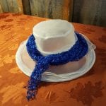 white hat with blue scarf