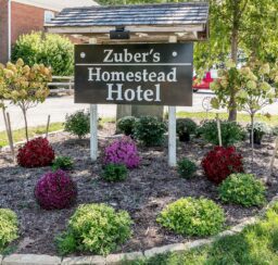 Zuber's Homestead Hotel entrance sign and flowers