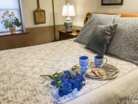 #4 The Glimpse of Amana room with blue flowers on bed