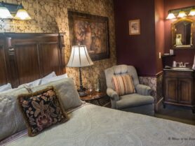 #7 The Vintner room with bed, recliner and vanity sink