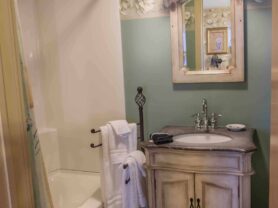 bathroom with vanity, tub