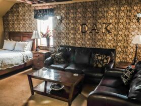 The Iowa Grand Oak Room with bed, sofas, coffee table