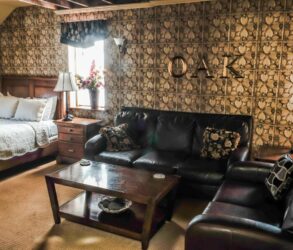 The Iowa Grand Oak Room with bed, sofas, coffee table