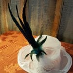 white hat with green feather