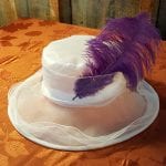 white hat with purple feather